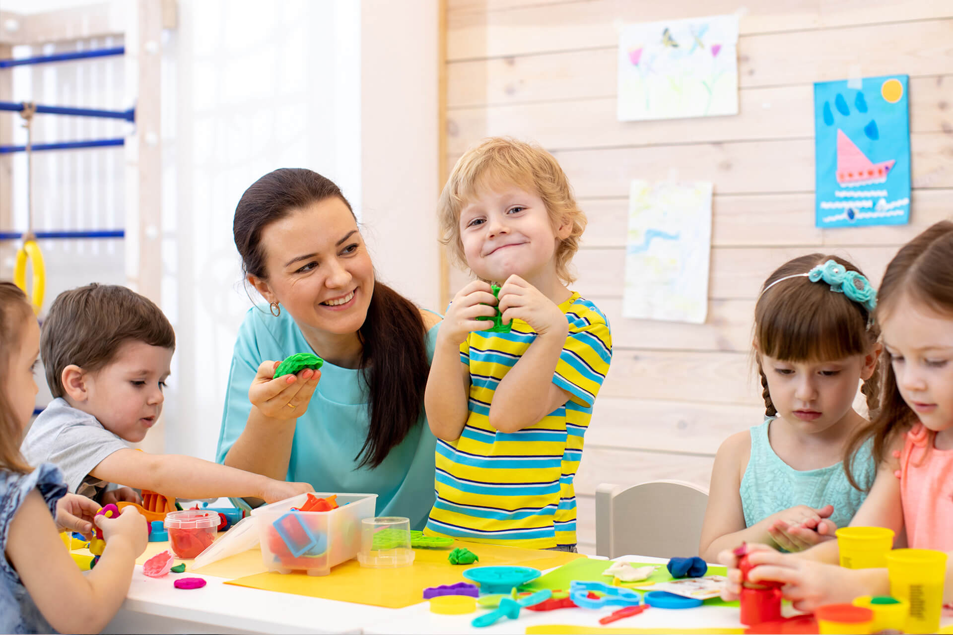 Education | Kita | Kinder mit Lehrer Form aus Knetmasse im Kindergarten