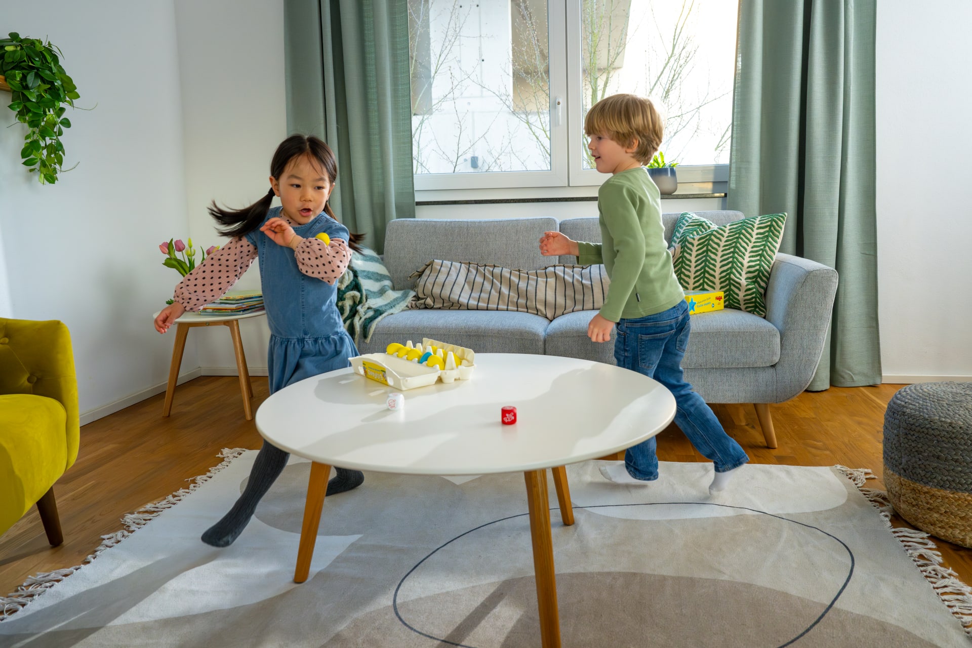 Bewegungsspiele Kinder | Kind springt auf hellgrünen Hüpfpolster