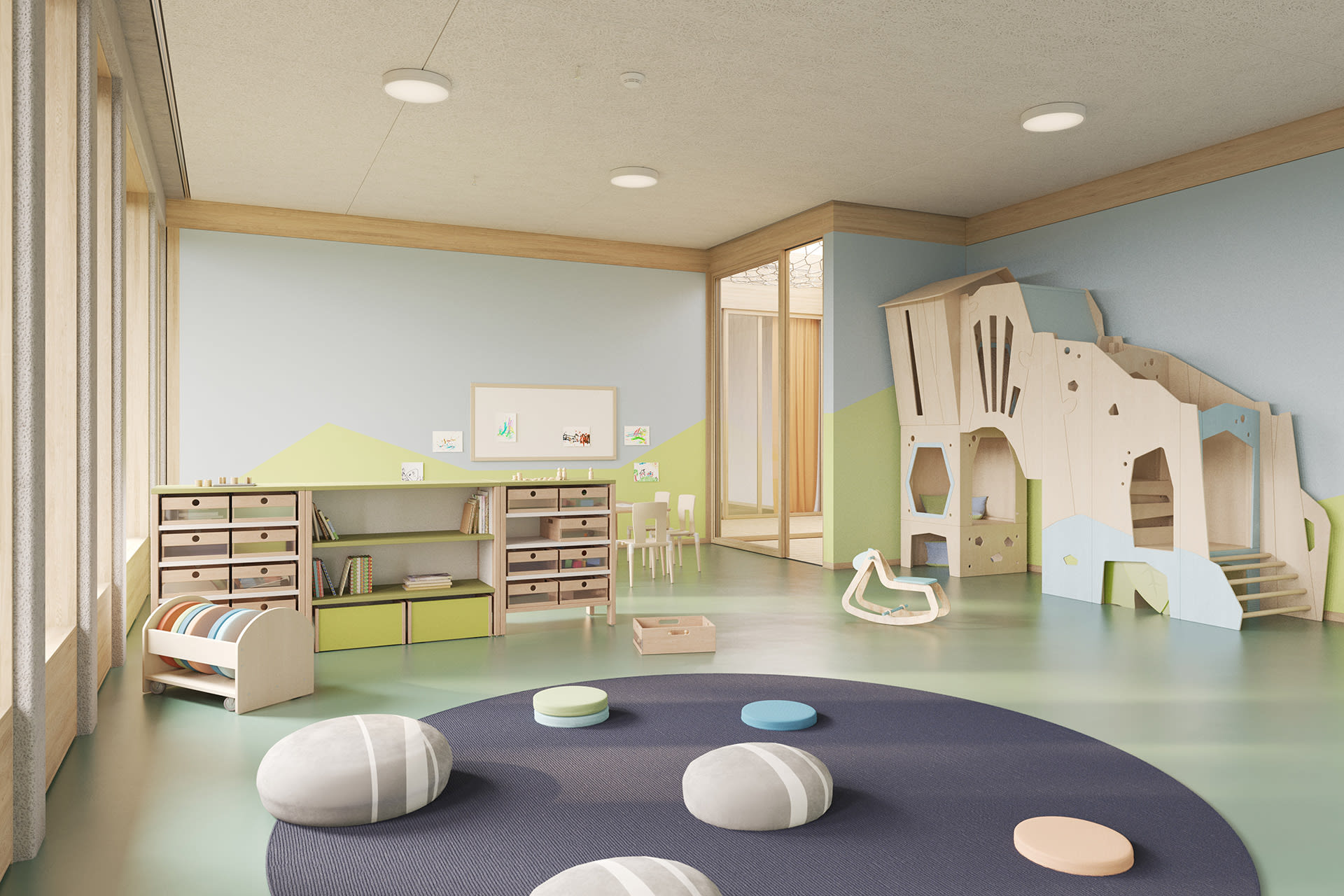  Farbgestaltung von Räumen |  Raum mit Spielturm in Naturholz und blauen und grünen Elementen steht an der Wand in der Mitte liegt ein graue runde Matte mit blauen, grünen und grauen Sitzkissen
