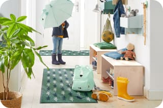 Was braucht man für Kindergarten und Kita | Kind mit Regenschirm im Flur