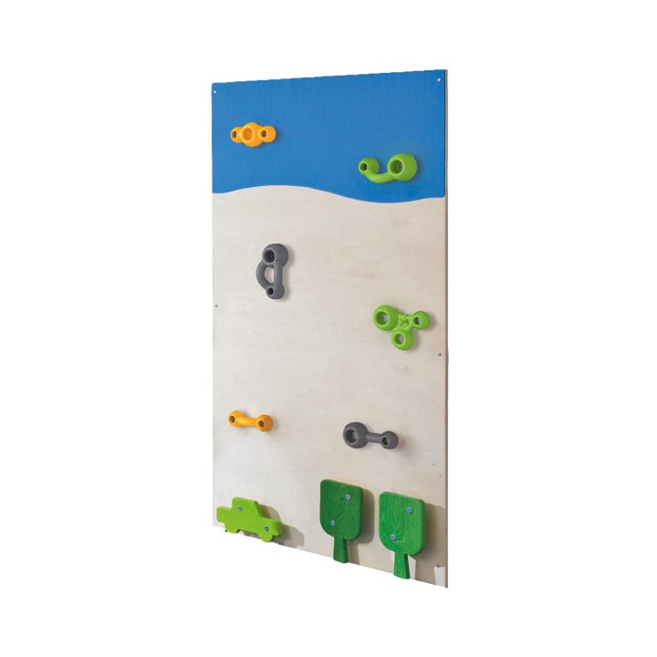 Eine Indoor-Kletterwand für Kinder mit farbenfrohen Klettergriffen in Orange, Grün und Grau, die abstrakten Formen, Bäumen und einem Auto nachempfunden sind, vor einem blauen und beigen Hintergrund.