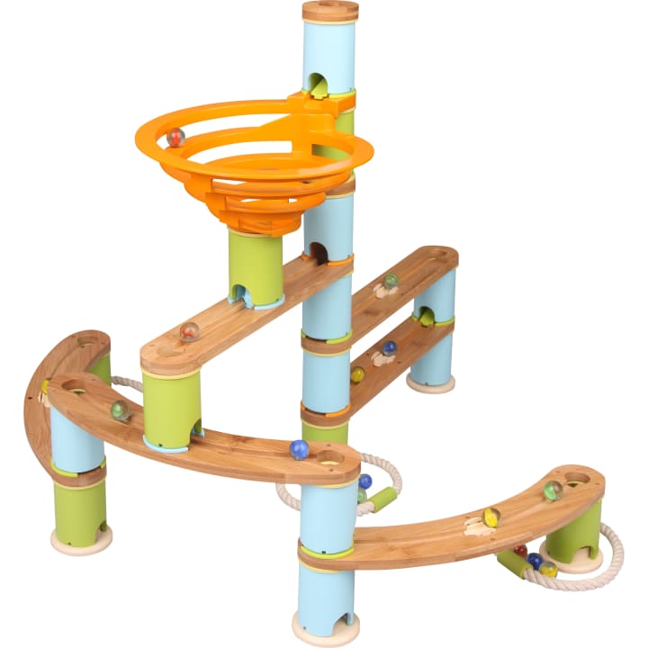 Eine hölzerne Kugelbahn mit blauen und grünen Stützen, gebogenen Holzbahnen und einem orangefarbenen Spiraltrichter an der Spitze. Mehrere bunte Murmeln werden auf verschiedenen Teilen der Bahn platziert.
