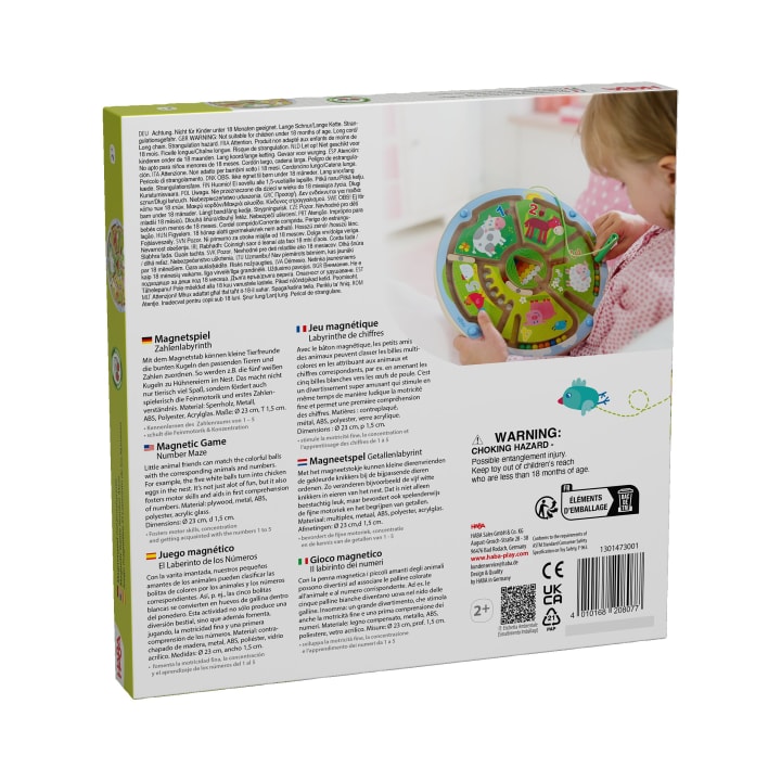 Auf der Rückseite einer Spielzeugkiste sind Sicherheitswarnungen, Produktinformationen in mehreren Sprachen, Recyclingsymbole und das Bild eines Kindes abgebildet, das mit einem magnetischen Spiel mit einer bunten Tafel und magnetischen Teilen spielt.