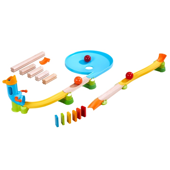 Ein Murmelbahn-Spielzeugset mit bunten Kunststoff- und Holzbahnen, einer blauen Spirale, Rampen, Dominosteinen und drei Murmeln. Die Teile sind in einer Schleife angeordnet, durch die die Murmeln rollen können.