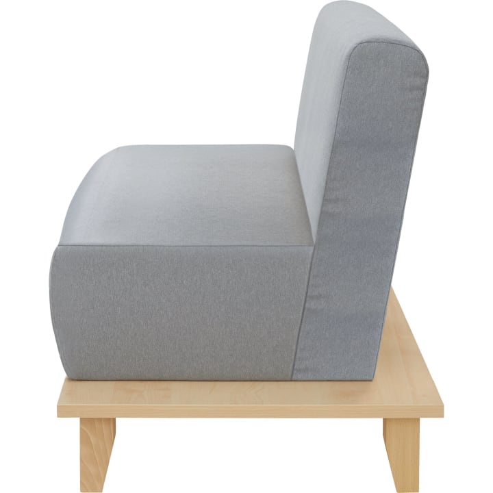 Ein grau gepolstertes, armloses Sofa mit hoher Rückenlehne, das auf einem hellen Holzsockel mit vier Beinen steht, von der Seite gesehen.