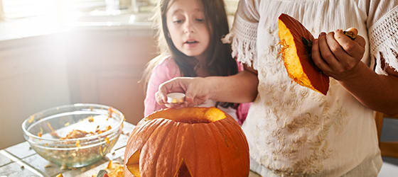 mother_and_daughter_having_fun_carving_pumpkin02.jpg