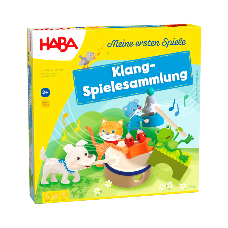 Eine gelbe Haba-Spielschachtel mit der Aufschrift Klang-Spielesammlung. Das Cover zeigt Illustrationen von einem Hund, einer Katze, einem Frosch und einem Kaninchen, die Musikinstrumente spielen. Das Spiel ist für die Altersgruppe 2+ und Teil von Meine ersten Spiele.
