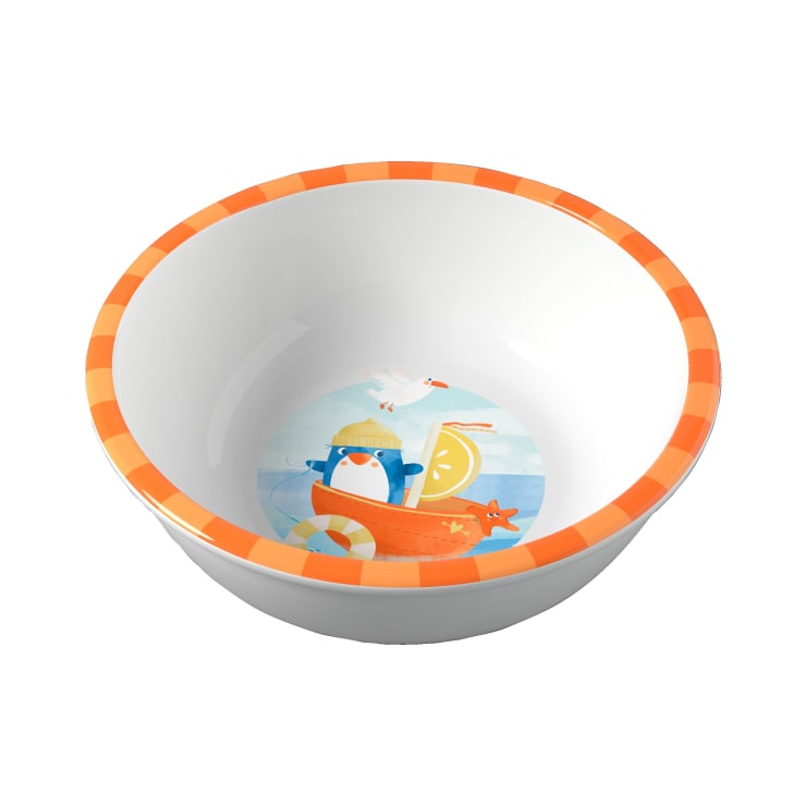 Weiße Schale mit orange-gelb kariertem Rand, auf der ein Pinguin am Strand abgebildet ist, mit einem Segelboot, einer Zitronenscheibe, einem Seestern und einer Möwe am unteren Rand.