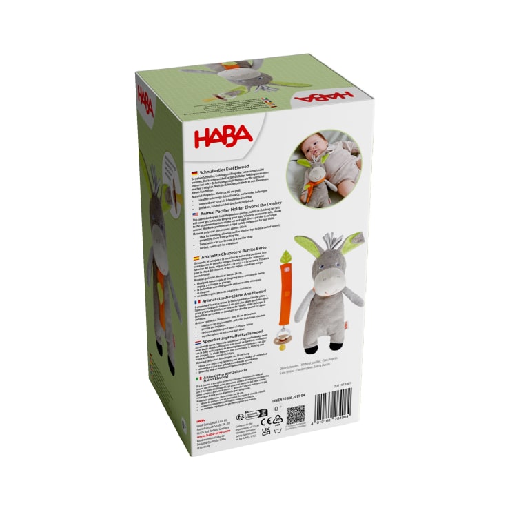 Die Rückseite der HABA-Spielzeugverpackung zeigt die Abbildung eines Eselplüschs, ein Foto eines Babys, das das Spielzeug hält, Produktinformationen in mehreren Sprachen, Sicherheitshinweise und das Firmenlogo.