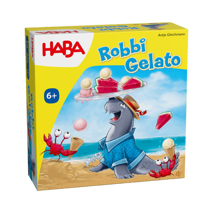 Eine gelbe Schachtel für das Spiel Robbi Gelato von HABA. Sie zeigt eine Robbe mit blauem Hemd und Hut, die Eis auf der Nase balanciert, und zwei rote Krabben mit Eistüten am Strand. Geeignet für Kinder ab 6 Jahren.