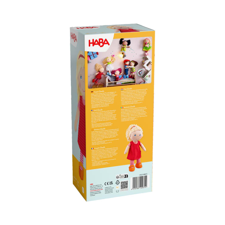 Die Rückseite einer HABA-Puppenschachtel zeigt Produktinformationen in mehreren Sprachen, ein Bild von Kindern, die mit Puppen spielen, einen Strichcode, Sicherheitssymbole und ein Foto der Puppe mit blondem Haar und rotem Kleid.