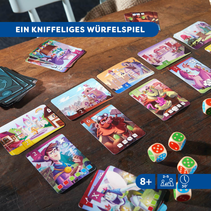 Mehrere bunt illustrierte Karten liegen auf einem Holztisch neben mehreren Würfeln mit verschiedenfarbigen Flächen. Auf einem blauen Banner steht in deutscher Sprache "EIN KNIFFELIGES WÜRFELSPIEL". Spielschachteln und Karten sind ebenfalls zu sehen.