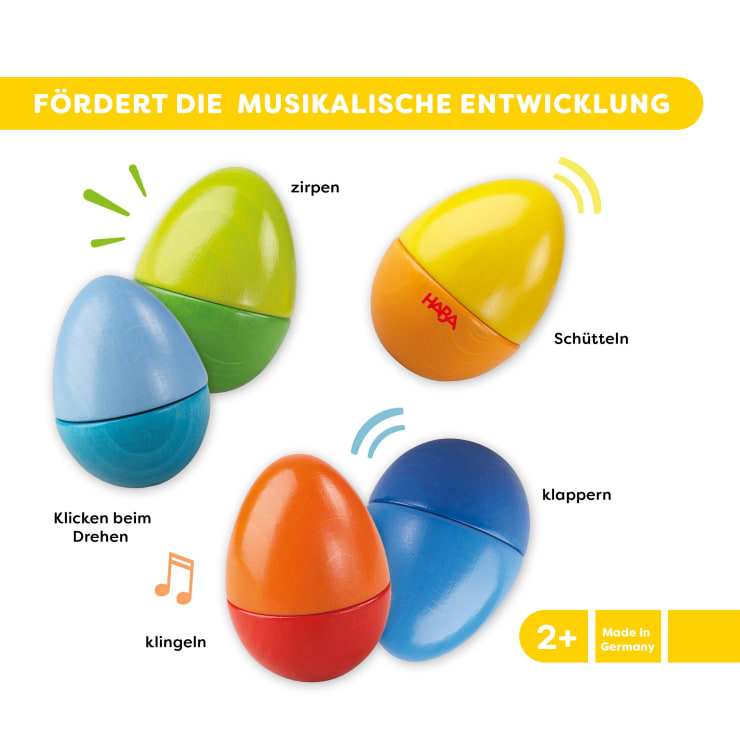 Vier bunte, eiförmige Musikspielzeuge in verschiedenen Farbkombinationen sind mit deutschen Etiketten abgebildet, die ihre Klänge und Aktionen beschreiben: Zirpen, Klicken, Klingeln, Schütteln und Klatschen. Der Text hebt die musikalische Entwicklung hervor.