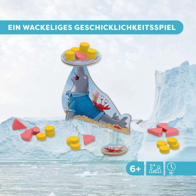 Ein Brettspiel mit einer balancierenden Robbenfigur, die gelbe Scheiben auf ihrer Nase hält, umgeben von roten Dreiecken und gelben Scheiben, vor einem illustrierten eisigen Hintergrund. Oben steht ein Text in deutscher Sprache.