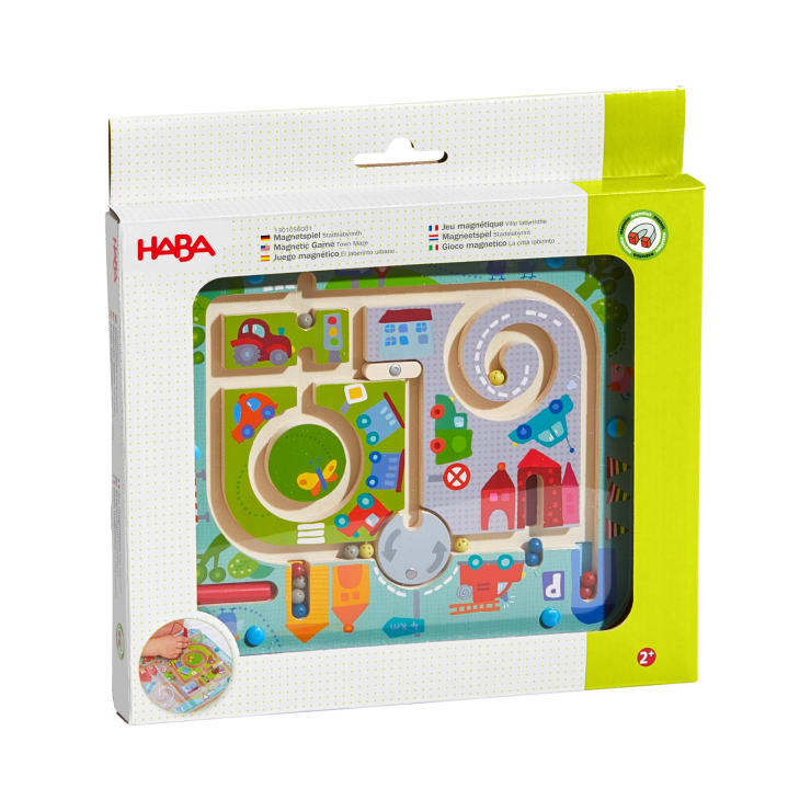 Ein verpacktes HABA-Magnetspiel mit einem farbenfrohen Stadtthema mit Straßen, Fahrzeugen, Gebäuden und einem Spiralpfad, das für Kinder ab 2 Jahren geeignet ist. Die Verpackung ist überwiegend weiß und grün.