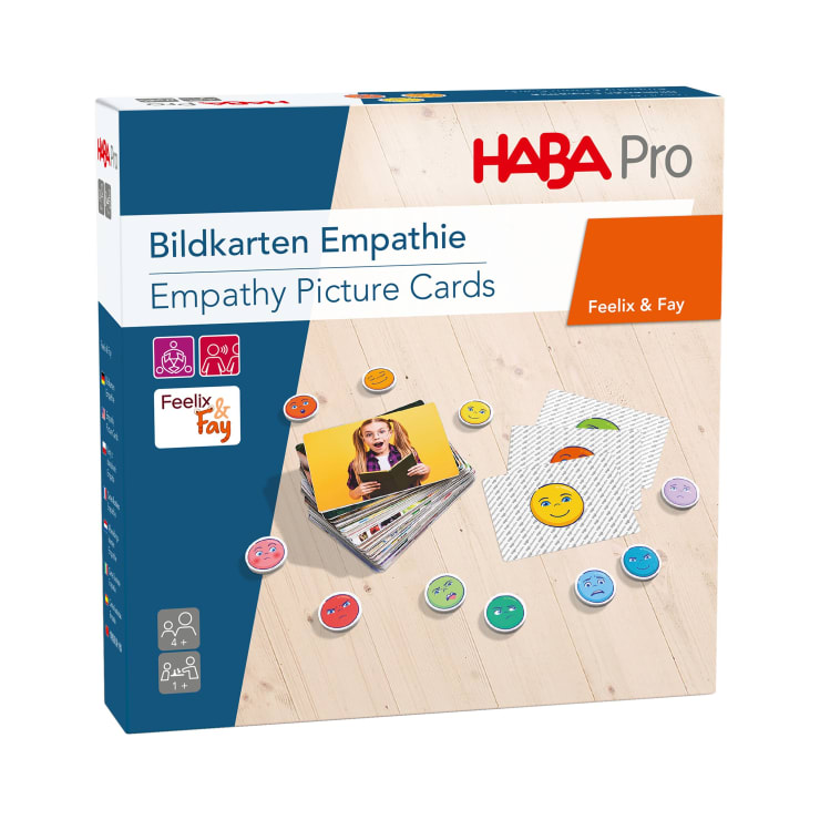 Eine Schachtel mit HABA education Empathy Picture Cards von Wehrfritz, mit einem Foto des Kartensets, runden Spielsteinen mit Gesichtsausdrücken und Text in Deutsch und Englisch. Das Produkt ist für die Entwicklung von Empathie gekennzeichnet.