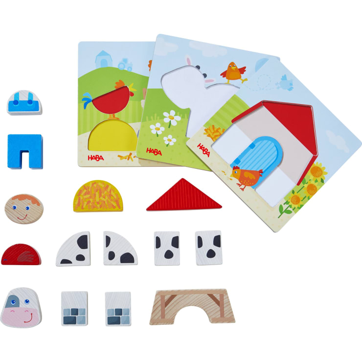Ein Kinderpuzzleset zum Thema Bauernhof mit illustrierten Tafeln und verschieden geformten Holzteilen, darunter Tiermuster, geometrische Formen und Bauernhofelemente wie eine Scheune und ein Heuhaufen, die auf einer weißen Fläche ausgelegt sind.