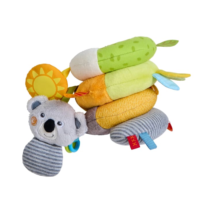 Ein plüschiges, mehrfarbiges Spiral-Krippenspielzeug mit einem grauen Koala-Kopf, einer Sonne und verschiedenen gemusterten Abschnitten mit Stoffanhängern und Schlaufen vor einem weißen Hintergrund.