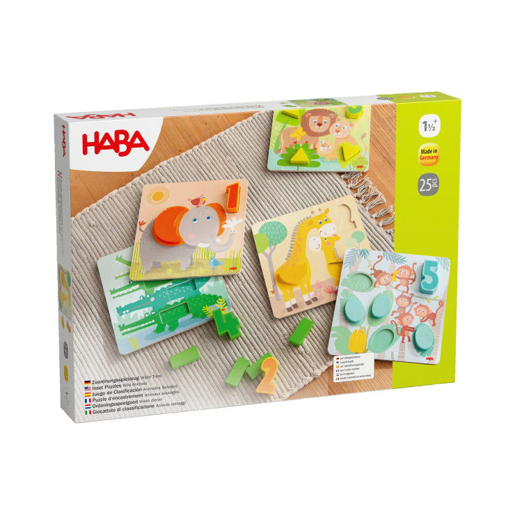 Eine Schachtel mit HABA-Kinderpuzzles enthält verschiedene Holzpuzzles und Zahlenteile mit Tiermotiven. Die Verpackung zeigt fertige Puzzles mit Abbildungen von Nilpferd, Löwe, Giraffe, Krokodil und der Zahl Fünf.