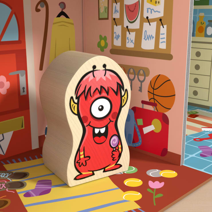 Ein Holzklotz mit einem roten, einäugigen Cartoon-Monster liegt auf einem bunten Spielzimmerboden. Im Hintergrund sind eine Garderobe, ein Basketball, ein Koffer und ein Teil einer Küche durch eine Tür sichtbar.