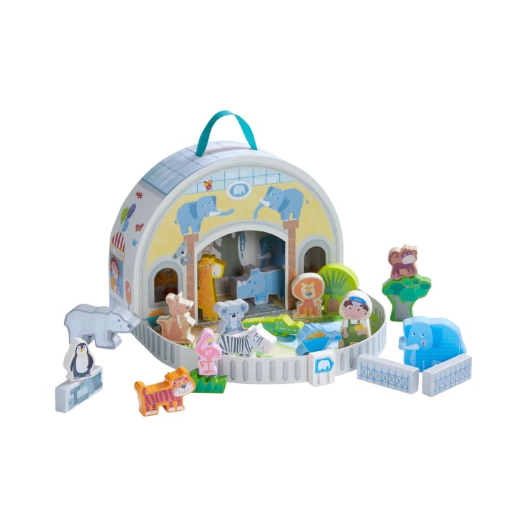 Ein hölzernes Zoospielset mit einer Tragetasche in Form eines Zoogebäudes mit aufgemalten Tierfiguren wie Elefant, Pinguin, Löwe, Zebra, Nashorn, Giraffe, Affe und Nilpferd.