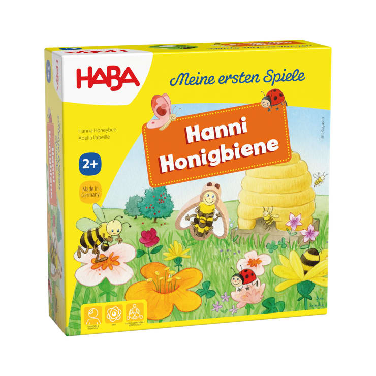 Eine gelbe Schachtel für das Kinderspiel Hanni Honigbiene von HABA, mit illustrierten Bienen, Blumen, einem Bienenstock und Käfern. Die Schachtel ist für Kinder ab 2 Jahren geeignet und gehört zur Reihe Meine ersten Spiele.
