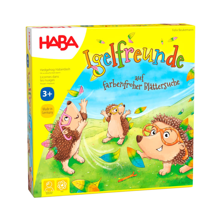 Die Abbildung zeigt eine farbenfrohe Schachtel für das Spiel Igelfreunde von HABA, auf der Cartoon-Igel mit Blättern auf einer grünen Wiese spielen. Die Schachtel ist gelb und für Kinder ab 3 Jahren geeignet.