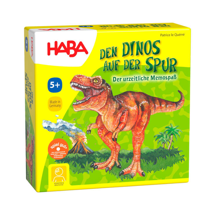 Die Abbildung zeigt eine gelbe Schachtel des Spiels Den Dinos auf der Spur von HABA, auf der ein roter Dinosaurier abgebildet ist. Die Schachtel enthält einen deutschen Text und gibt an, dass es für Kinder ab 5 Jahren geeignet ist.