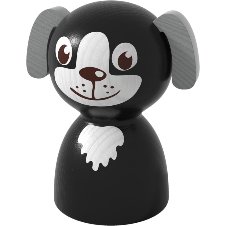 Eine Holzfigur in Form eines stilisierten schwarzen Hundes mit grauen Ohren, großen weißen und braunen Augen und einem weißen Fleck auf der Brust, mit einfachen, cartoonartigen Gesichtszügen.