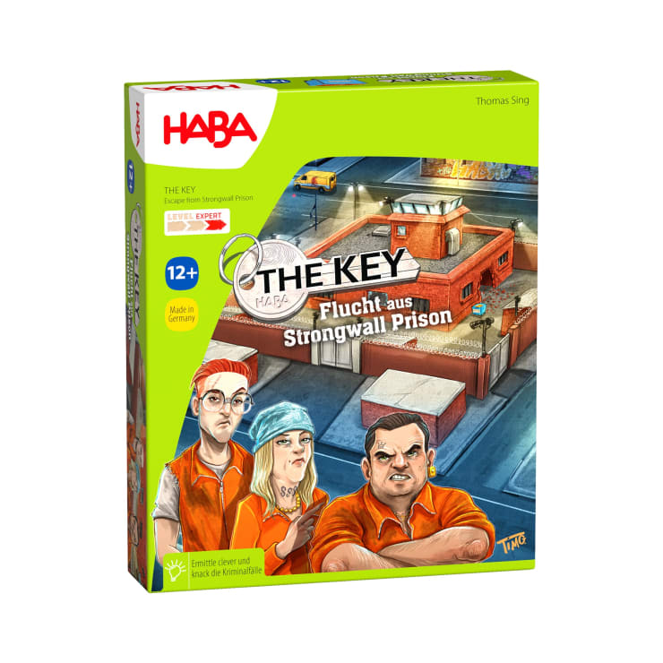 Vorderseite der Schachtel eines Brettspiels mit dem Titel The Key: Flucht aus Strongwall Prison von HABA, zeigt drei illustrierte Gefangene in orangefarbenen Uniformen mit einem Gefängnisgebäude im Hintergrund. Empfohlen für Kinder ab 12 Jahren.