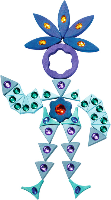 Eine Figur aus bunten geometrischen Formen mit Juwelenverzierungen. Der Kopf ist kreisförmig mit einem blauen blumenartigen Kopfschmuck, während die Gliedmaßen und der Körper aus Dreiecken und anderen Formen in Blau- und Grüntönen bestehen.