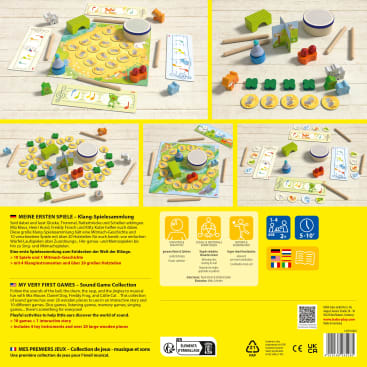 Ausgestellt ist ein Brettspielset mit verschiedenen Komponenten, darunter Holzplättchen, Tierfiguren, ein Schläger, ein Spielbrett mit Bildern, Anleitungsblätter und illustrierte Spielsteine. Die Anleitungen in mehreren Sprachen sind unter den Fotos abgebildet.