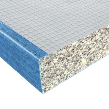 Die Nahaufnahme einer Matratzenecke zeigt einen Querschnitt mit einer blauen Stoffaußenschicht, einer grauen gittergemusterten Deckschicht und einem dicken gesprenkelten Schaumstoff im Inneren.