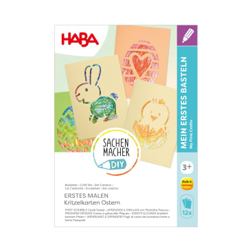 Eine Bastelschachtel mit der Aufschrift HABA mit drei Kritzelbildern zum Thema Ostern, die einen Hasen, ein Ei und ein Küken zeigen. Der Text auf der Schachtel ist in Deutsch und Englisch und weist darauf hin, dass sie für Kinder ab 3 Jahren geeignet ist.