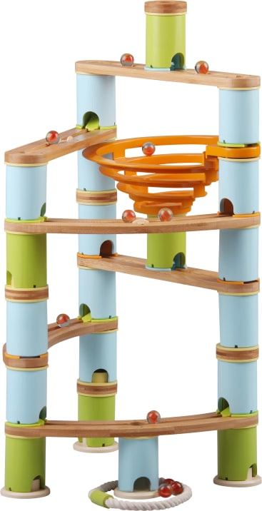 Eine hölzerne Murmelbahn mit blauen, grünen und natürlichen Holzsäulen, einer gelben Spiralbahn, horizontalen Rampen und Murmeln, die in der gesamten Struktur positioniert sind, mit einem Seilring am Boden.