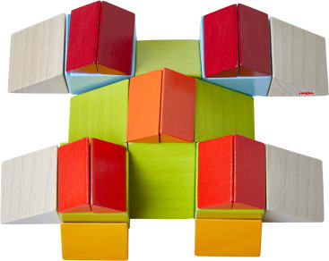 Eine symmetrische Anordnung von bunten Holzklötzen, darunter rote, orange, grüne und helle Holzfarben, die ein geometrisches Muster auf weißem Hintergrund bilden.